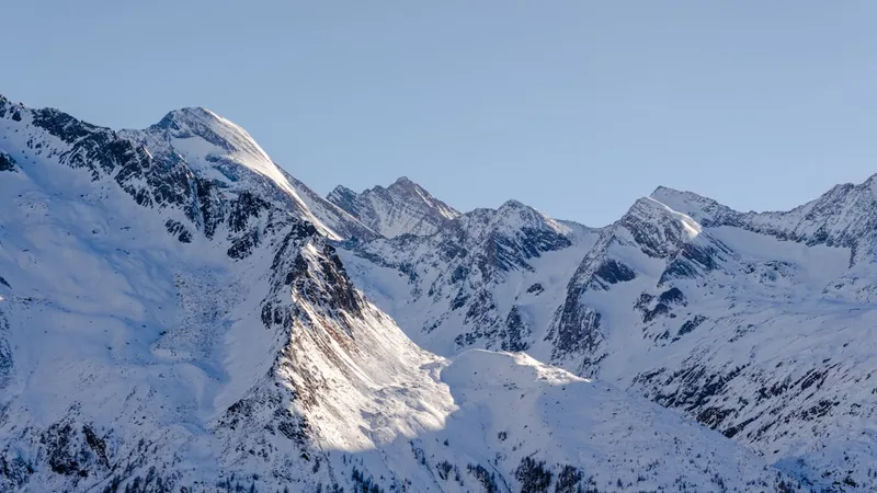 Snow-covered mountains under a clear blue sky